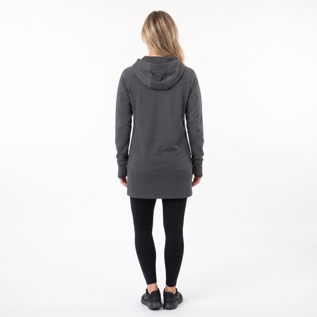 A woman viewed from behind wearing a dark gray heathered hooded sweatshirt, black leggings, and black sneakers against a plain white studio background.