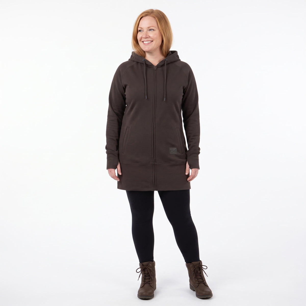 A woman modeling a dark brown hooded zip-up jacket, black leggings, and brown lace-up boots against a plain white studio background.