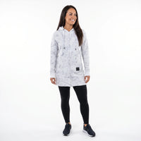 A woman modeling a light gray and white marble-patterned zip-up hooded jacket, paired with black leggings and dark sneakers, against a solid white background.