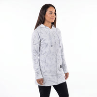 A woman modeling a light gray and white marble-patterned zip-up hoodie with black drawstrings, shown against a plain white studio background.