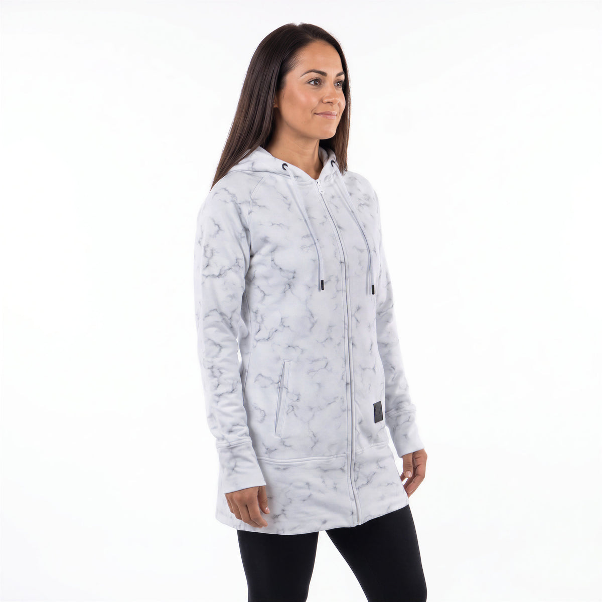 A woman modeling a light gray and white marble-patterned zip-up hoodie with black drawstrings, shown against a plain white studio background.