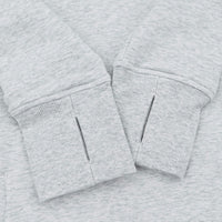 Close-up of a light heather gray sweatshirt cuff with a vertical slit detail on the front.